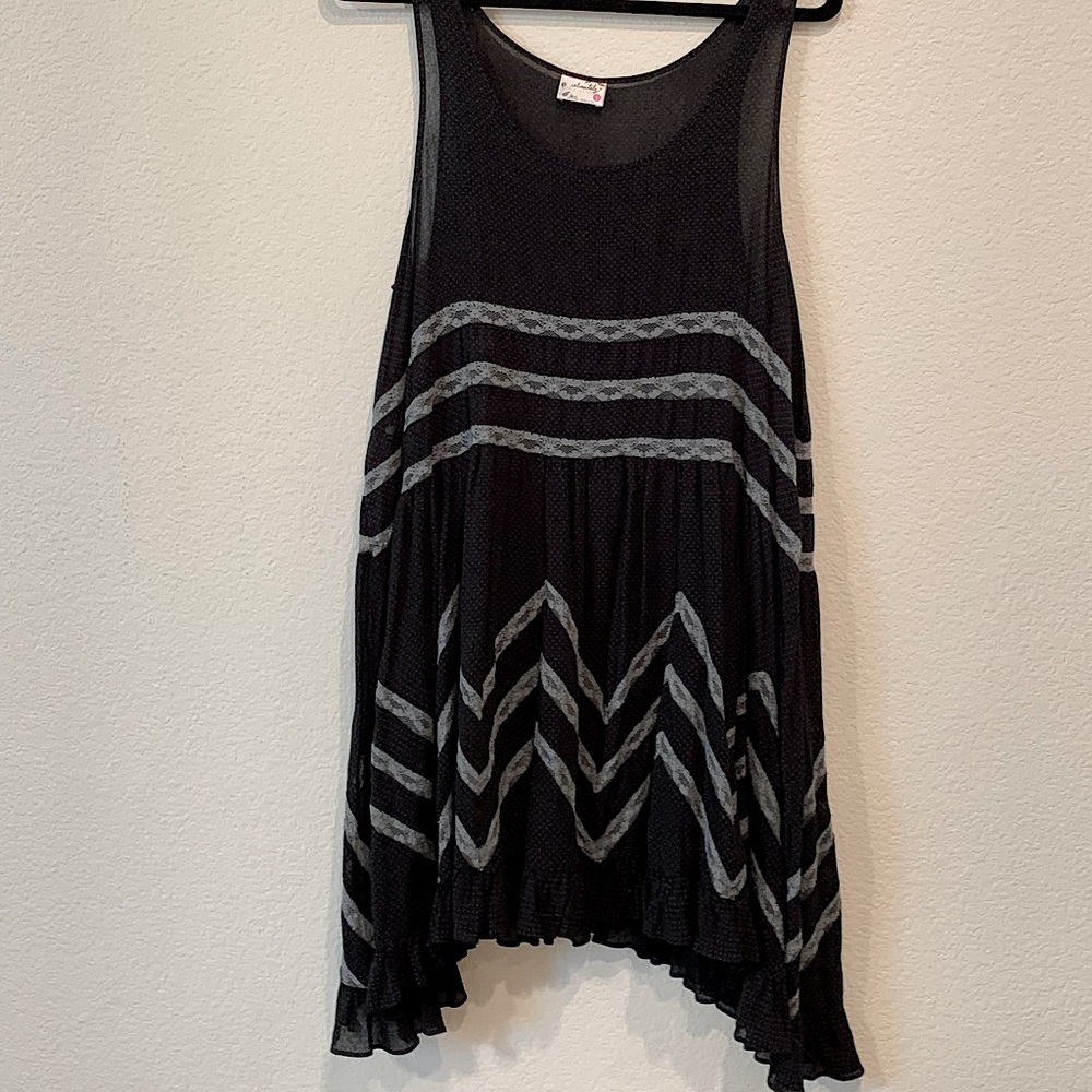 Sheer dotted slip dress with lace inset throughout. Ruffled hem.